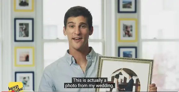 man standing with picture frame